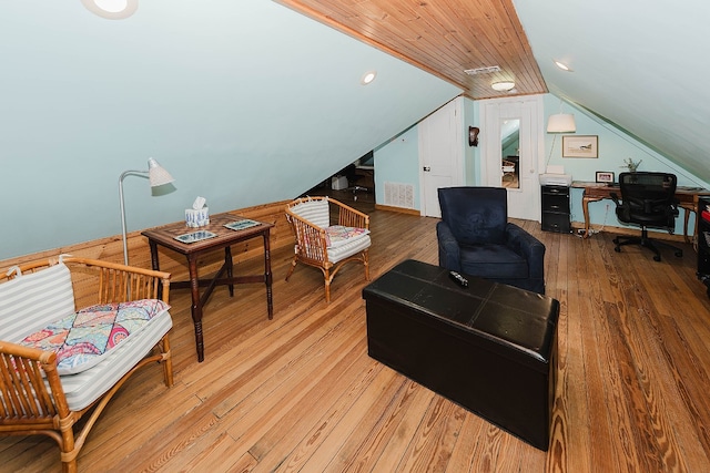 living room with lofted ceiling and hardwood / wood-style floors