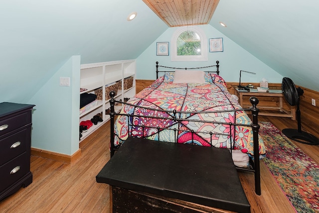 bedroom featuring light hardwood / wood-style floors and vaulted ceiling