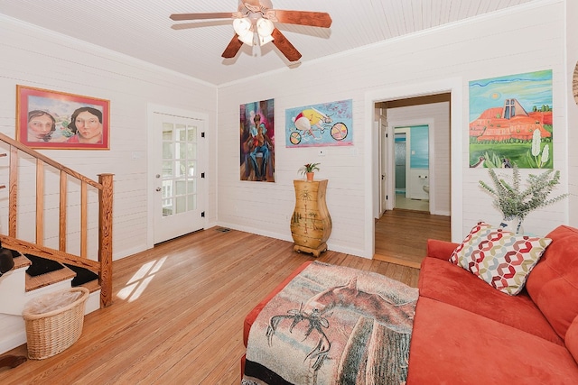 living room with ceiling fan, hardwood / wood-style flooring, and crown molding