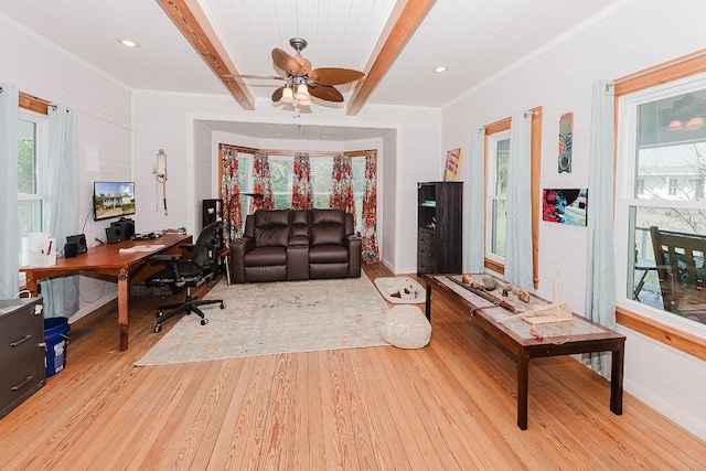 home office with light wood-type flooring, ceiling fan, beamed ceiling, and a wealth of natural light