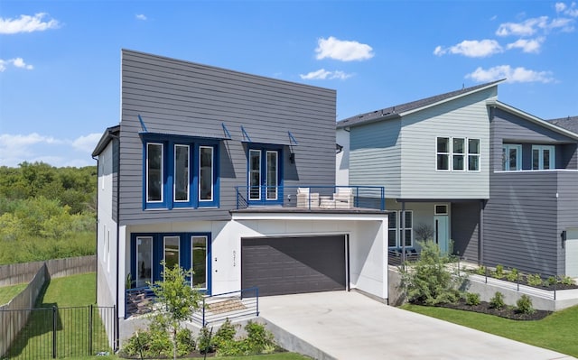 contemporary home featuring a front yard and a garage