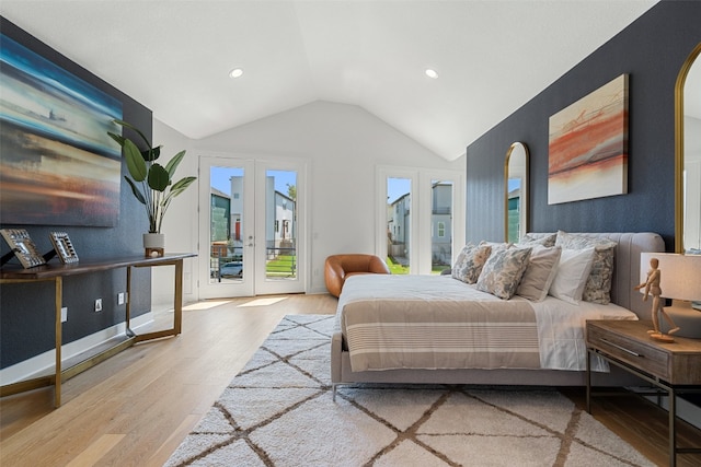 bedroom with french doors, light hardwood / wood-style flooring, access to exterior, and lofted ceiling