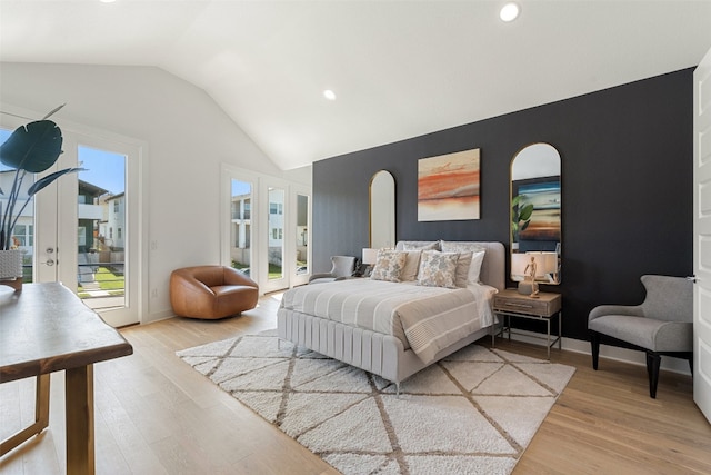 bedroom featuring lofted ceiling, access to exterior, french doors, and hardwood / wood-style flooring