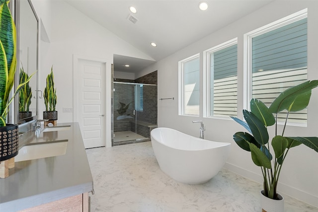 bathroom with plus walk in shower, vaulted ceiling, and vanity