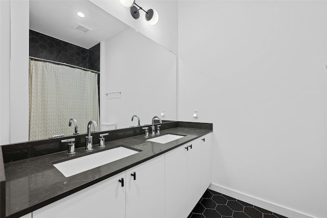 bathroom featuring vanity, toilet, and tile patterned floors