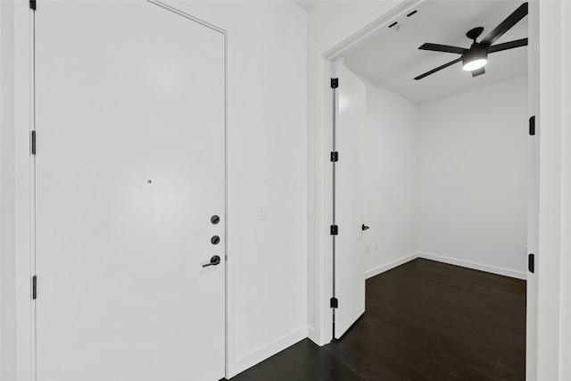 interior space with ceiling fan and dark hardwood / wood-style floors