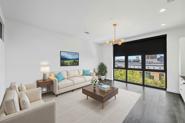 living room featuring light hardwood / wood-style floors and a notable chandelier