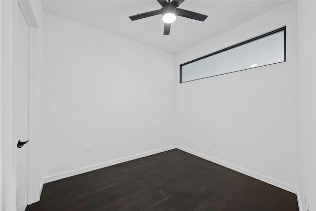 empty room featuring ceiling fan and dark hardwood / wood-style floors