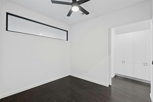 unfurnished room featuring ceiling fan and dark hardwood / wood-style flooring