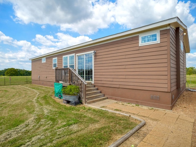 rear view of property featuring a lawn