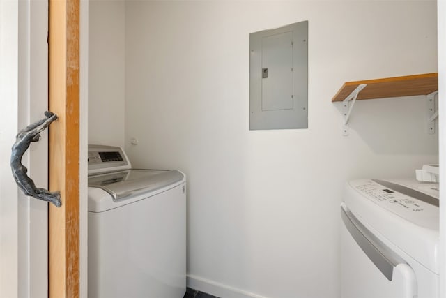 laundry area featuring electric panel and washing machine and clothes dryer