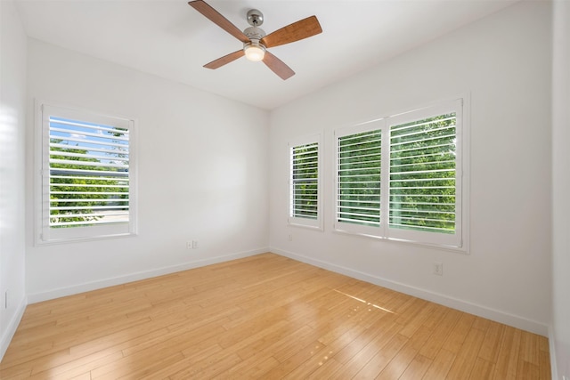 spare room with ceiling fan and light wood-type flooring