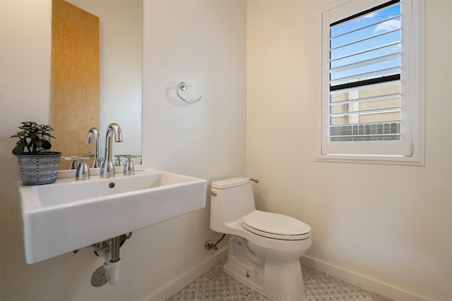 bathroom with tile patterned flooring, sink, and toilet