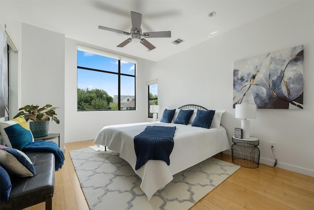 bedroom with ceiling fan and light wood-type flooring