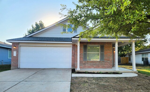 view of front of home with covered porch and a garage