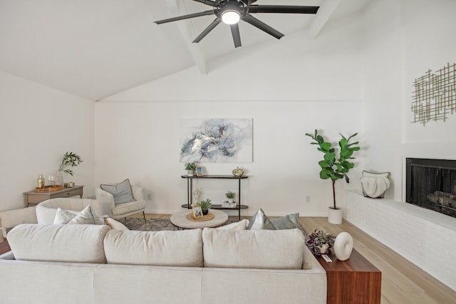 living room featuring lofted ceiling with beams, ceiling fan, and hardwood / wood-style flooring