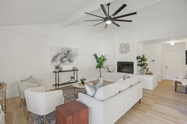 living room featuring ceiling fan, beam ceiling, light hardwood / wood-style floors, and high vaulted ceiling