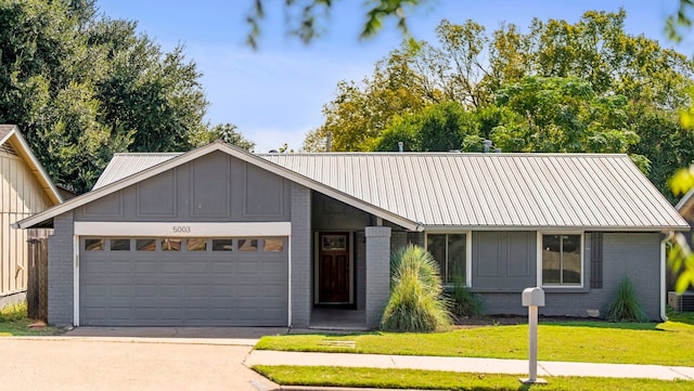 view of front of home with a garage and a front yard