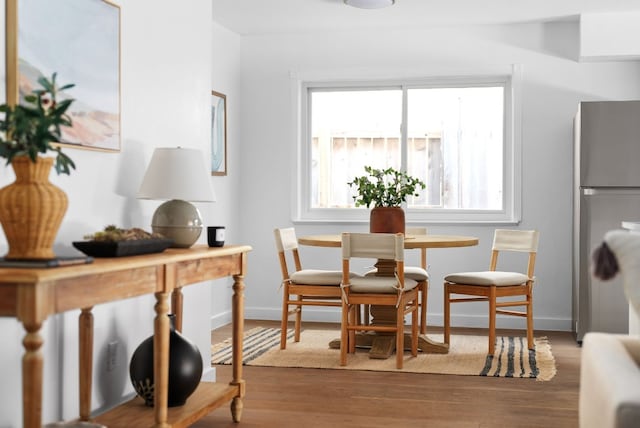 dining space with hardwood / wood-style floors