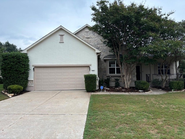 405 Dawson Trl, Georgetown, TX 78633 - view of front of house with stone siding, stucco siding, an attached garage, driveway, and a front lawn