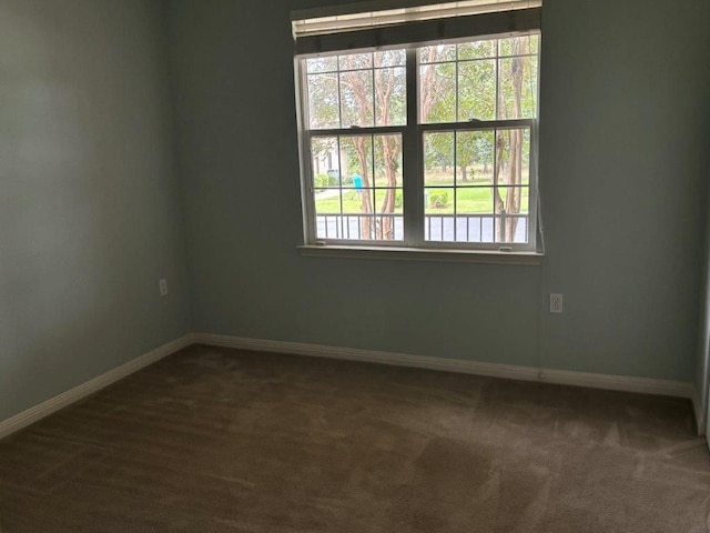 405 Dawson Trl, Georgetown, TX 78633 - unfurnished room featuring baseboards and dark colored carpet
