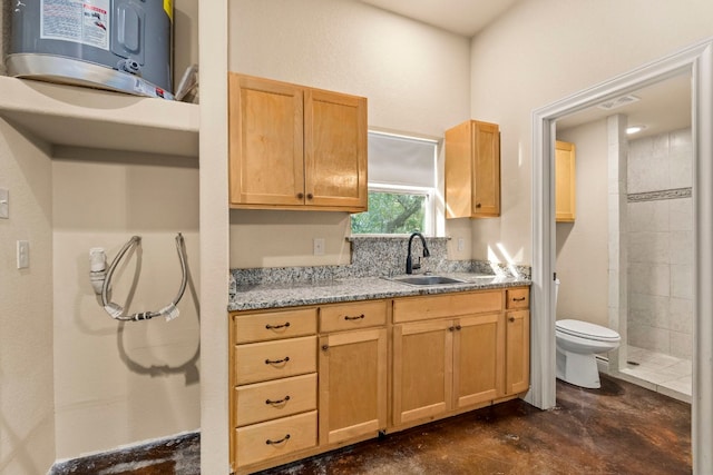 bathroom featuring a tile shower, electric water heater, concrete flooring, vanity, and toilet