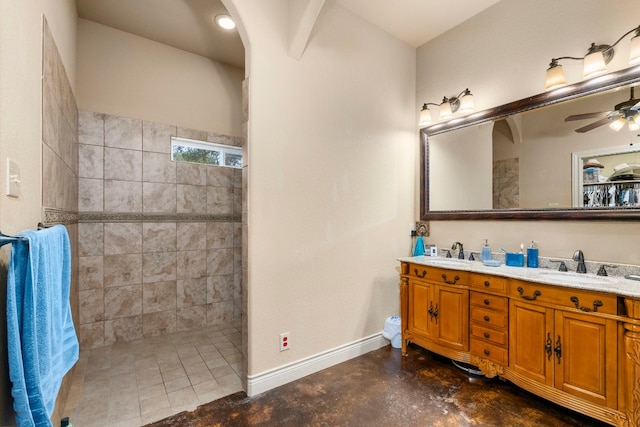 bathroom featuring concrete floors, tiled shower, vanity, and ceiling fan