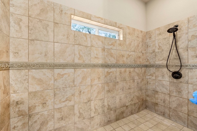 bathroom with a tile shower