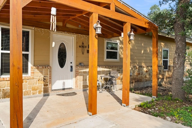 view of exterior entry with covered porch