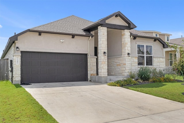 view of front of house featuring a front yard and a garage