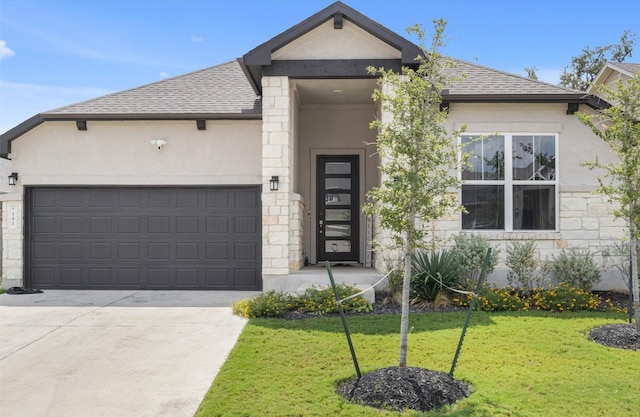 view of front of home featuring a front yard and a garage