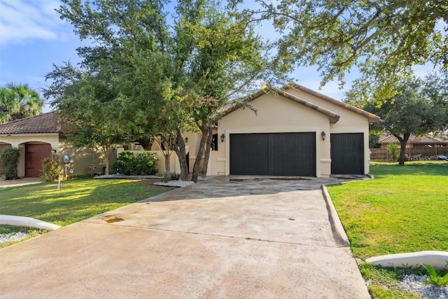 view of front facade featuring driveway, a garage, fence, a front lawn, and stucco siding