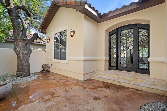 15009 General Williamson, Austin, TX 78734 - doorway to property featuring stucco siding, a tiled roof, and french doors
