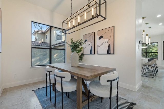 dining area featuring baseboards and recessed lighting