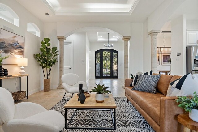 15009 General Williamson, Austin, TX 78734 - living area featuring ornate columns, a tray ceiling, arched walkways, and a chandelier