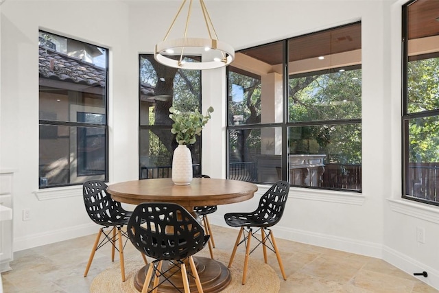 15009 General Williamson, Austin, TX 78734 - dining room featuring baseboards, stone finish flooring, and a chandelier
