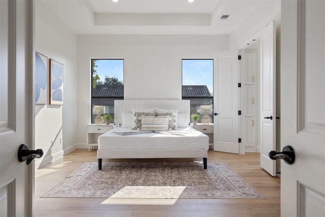 15009 General Williamson, Austin, TX 78734 - bedroom with a raised ceiling, light wood finished floors, recessed lighting, and baseboards