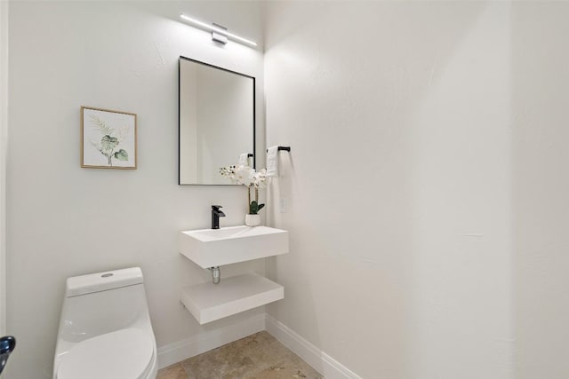 15009 General Williamson, Austin, TX 78734 - half bath featuring toilet, baseboards, and a sink