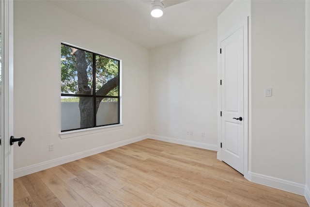 empty room featuring light wood-type flooring, ceiling fan, and baseboards