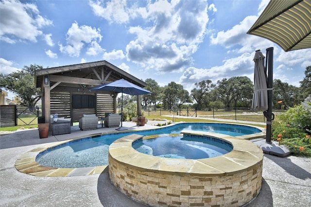 view of swimming pool with an in ground hot tub and a patio area