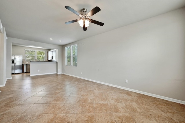 unfurnished living room featuring ceiling fan