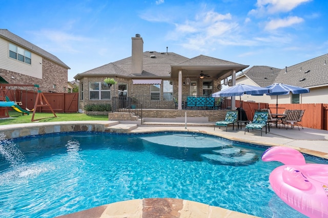 view of pool with ceiling fan and a patio