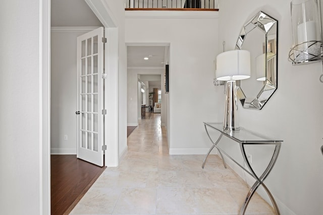 hallway featuring light wood-type flooring and crown molding