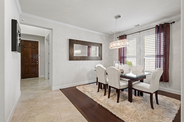 dining space with ornamental molding and a notable chandelier