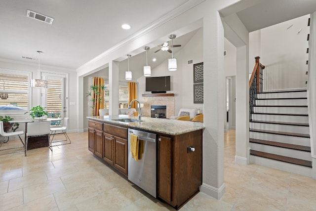 kitchen with pendant lighting, crown molding, sink, light stone countertops, and stainless steel dishwasher