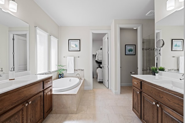 bathroom with tile patterned flooring, plus walk in shower, and vanity