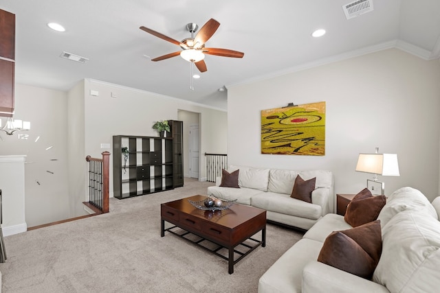 carpeted living room with crown molding and ceiling fan