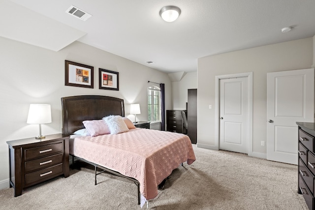 bedroom featuring baseboards, visible vents, and light colored carpet