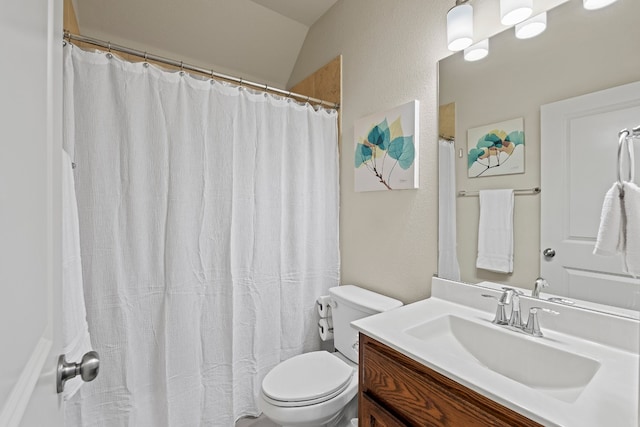 bathroom featuring vaulted ceiling, vanity, walk in shower, and toilet