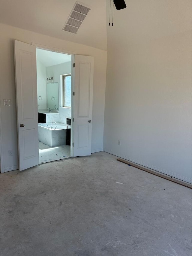 unfurnished bedroom featuring concrete flooring, visible vents, ensuite bath, and a ceiling fan